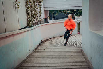 Image showing Women in sports clothes running in a modern urban environment et night time. The concept of a sporty and healthy lifestyle