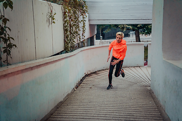 Image showing Women in sports clothes running in a modern urban environment et night time. The concept of a sporty and healthy lifestyle