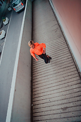 Image showing Women in sports clothes running in a modern urban environment et night time. The concept of a sporty and healthy lifestyle