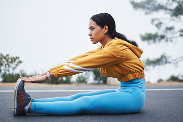 Image showing Sports, leg stretching and woman runner doing exercise on a outdoor road feeling serious. Workout, running training and wellness warm up of young female ready for sports and marathon run in mist