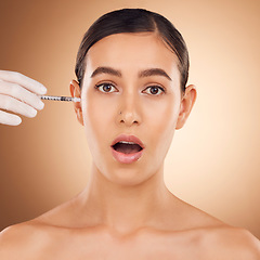 Image showing Plastic surgery surprise, hands or woman face with needle facial change, spa cosmetics process or studio skincare. Wow, medical injection or portrait female with aesthetic beauty on brown background