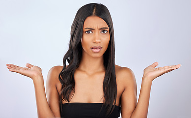 Image showing Indian woman, hair care or confused in studio portrait for healthy natural shine options or beauty choices. Face of young girl model, doubt or curly styling cosmetics in grooming on white background