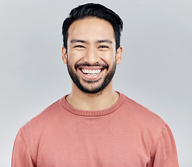 Image showing Face portrait, smile and happy Asian man in studio isolated on a white background or backdrop. Funny, fashion and young, confident and proud, handsome male model or person with positive mindset.