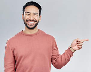 Image showing Smile, space and portrait of Indian man pointing with mockup and product placement isolated on white background. Promotion, information and person showing deal announcement in studio with launch idea