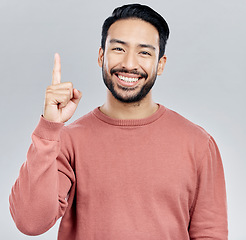 Image showing Smile, space and portrait of Indian man pointing up, mockup and product placement isolated on white background. Promotion, information and person showing deal announcement in studio with launch idea.