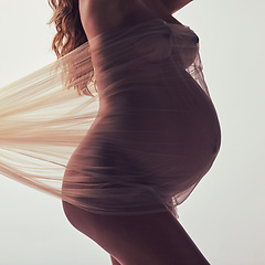 Image showing Woman, pregnancy and fabric with silhouette in studio with hands, touch and art by white background. Pregnant model, shadow and mom wellness with cloth for body, belly or stomach with dark aesthetic