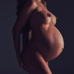 Image showing Pregnant, beauty and body with a woman nude in studio on a gray background posing as a mother. Pregnancy, skin and belly with a mom or mama standing naked, proud of her femininity or motherhood