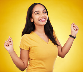 Image showing Happy, young and portrait of a beautiful woman isolated on a yellow background in a studio. Casual, smile and a gorgeous girl looking cheerful, cute and fashionable in a bright shirt on a backdrop