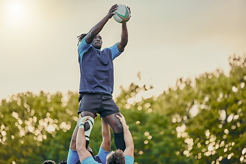 Image showing Sports, men and rugby and jump with team on field, playing game with energy and fitness, ball and action outdoor. Training, exercise and professional match, sport club with male group and active