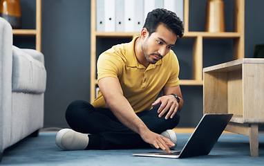 Image showing Remote work, typing and an Asian man with a laptop on the floor for entrepreneurship and freelancing. Serious, contact and an entrepreneur working on a computer, reading communication and an email