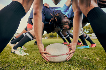 Image showing Sport, rugby ball and team on field, men playing game with energy and fitness with huddle together. Teamwork, scrum and ready for professional match, male sports club and outdoor with exercise