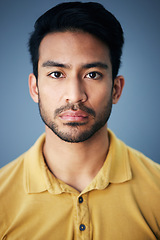 Image showing Focus, serious and portrait of a male in studio with moody, sadness or mental health problem. Tired, concentrating and Indian man model with burnout face expression isolated by gray background.