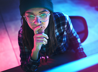 Image showing Cyber security, focus and woman hacker working on a computer in the basement at night for phishing. Database, password and ransomware with a female coder hacking a digital transformation network