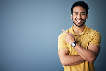 Image showing Studio mockup, portrait and happy man pointing at promotion announcement, branding copy space or advertising. Smile, happiness and commercial person gesture at marketing mock up on blue background