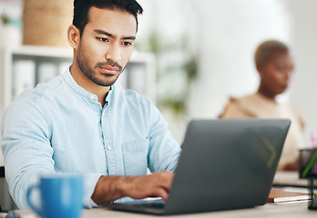 Image showing Asian man, laptop and typing in startup office for planning, schedule or proposal in workplace. Web design expert, computer and focus at desktop for development, goals and seo strategy on internet