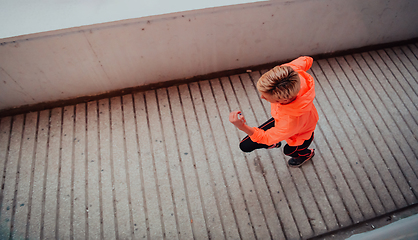 Image showing Women in sports clothes running in a modern urban environment et night time. The concept of a sporty and healthy lifestyle