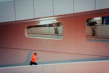 Image showing Women in sports clothes running in a modern urban environment et night time. The concept of a sporty and healthy lifestyle