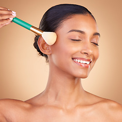 Image showing Makeup, beauty and brush with indian woman in studio for foundation, blush and self care. Glow, cosmetics and facial with female model isolated on brown background for shine, blusher and application