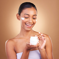 Image showing Skincare, beauty product lotion and glow of a happy woman with cosmetic and cream. Isolated, studio background and model with a smile from face cleaning, cosmetics and dermatology facial sunscreen