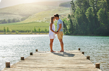 Image showing Couple holding hands on jetty, relax by lake and summer, travel and adventure, love and care outdoor. People in relationship, trust and bonding on vacation, man and woman are content with freedom