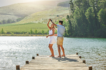 Image showing Lake, dancing and happy nature couple on outdoor quality time together, fun countryside adventure or bonding getaway. Freedom peace, water and playful woman, man or romantic people dance on love date