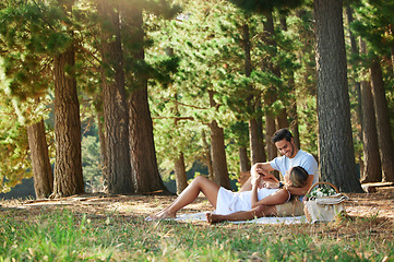 Image showing Couple on picnic, nature park and relax together outdoor, support and comfort with love and care while bonding. Summer, holiday with man and woman cuddle, happiness and relationship with trust