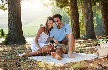 Image showing Couple on picnic, phone and relax together in nature, happy people with social media, travel with bonding outdoor. Happiness, man and woman, communication with trust and love in relationship