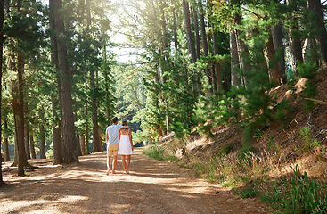 Image showing Back, love and nature with a couple in the forest, walking together on a romantic date for bonding or adventure. Freedom, travel or hiking with a man and woman outdoor for a walk during summer