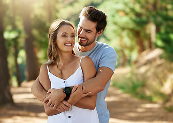 Image showing Couple hug in nature park, happy and relationship with love and trust, travel and adventure. Young people in forest, outdoor and happiness together with smile, embrace with commitment and care