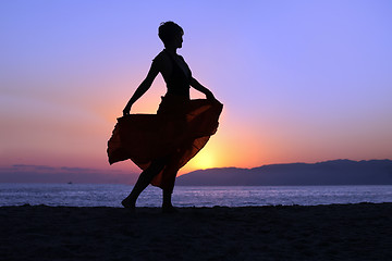 Image showing Woman walking on the beach