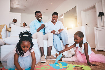 Image showing Playing, parents and children relax in living room for bonding, quality time and child development. Happy family, home and mother, father and kids on floor having fun with toys for learning and games