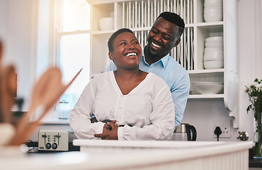 Image showing Hug, kitchen and happy black couple laugh, bond or enjoy quality time together, funny conversation or chat in Nigeria home. Love, marriage and African people humour, embrace and smile at comedy joke