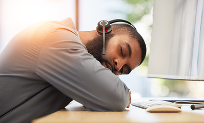 Image showing Black man, sleeping on desk and tired call center employee, insomnia or mental health problem with headset and mic. Burnout, fatigue and male consultant with stress, nap at work with customer service