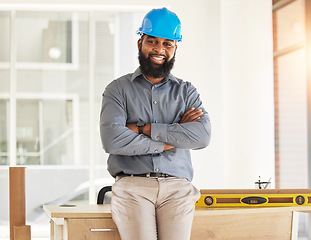 Image showing Engineering, crossed arms and portrait of male construction worker with confidence in his office. Happy, smile and African man industrial professional standing by a desk in industry building on site.