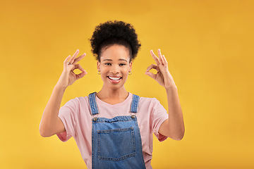Image showing Portrait, perfect and hand gesture with an excited black woman in studio on a yellow background. Smile, wow and okay with a happy young female person showing a sign of support, feedback or review