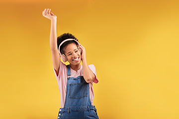 Image showing Headphones, music and happy black woman dance in studio isolated on a yellow background mockup space. African person, smile and listen to radio, podcast or sound for jazz, hip hop or streaming audio