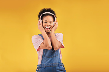 Image showing African girl, headphones and studio portrait with smile, youth fashion and sound by yellow background. Young student, gen z woman or model with audio tech, streaming subscription and happy for music