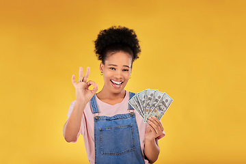 Image showing Okay, money and winner with portrait of black woman in studio for success, prize or achievement. Bonus, lottery and investment with person and cash on yellow background for dollar, profit or giveaway