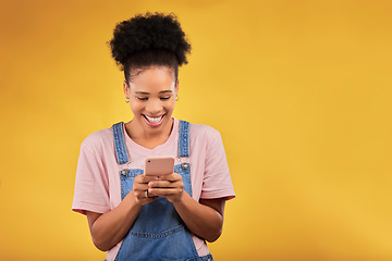 Image showing Mockup, typing and happy woman with phone in studio, texting or social media post with space on yellow background. Networking, chat online and model with cellphone mobile app, reading meme or email