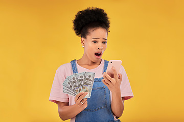 Image showing Surprise, money and winner with black woman and phone in studio for success, prize or deal. Bonus, lottery and online payment with person and cash on yellow background for dollar, profit or giveaway