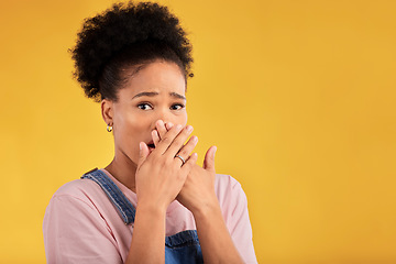 Image showing Shocked, surprise and portrait of woman with wow reaction to news isolated in a yellow studio background. Expression, omg and young female person covering mouth due to gossip or announcement