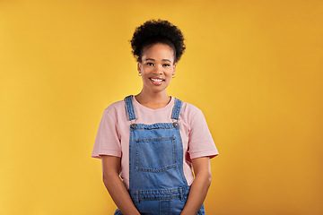 Image showing Fashion, portrait and happy black woman in studio with confidence, style and cool outfit on yellow background. Face, smile and stylish African female model pose with trendy and fashionable clothes