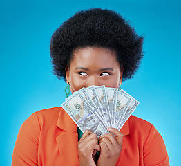 Image showing Cash, hide and a black woman lottery winner on a blue background in studio holding money for finance. Savings, investment or economy growth with a young female person excited for financial freedom