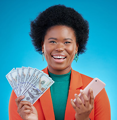 Image showing Black woman, money fan and phone in studio portrait with wow, surprise or happy for profit by blue background. African gen z girl, smartphone and cash with smile, winner or gambling app for giveaway