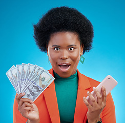 Image showing African woman, cash and phone in studio portrait with wow, surprise and happy for profit by blue background. Black gen z girl, smartphone and money with shock, winner and gambling app for giveaway