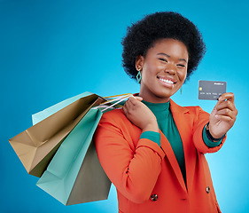 Image showing Credit card, shopping offer and woman in portrait for retail banking, finance and e commerce fintech or payment. Customer face, fashion model or african person, bag and debt on blue studio background