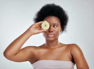 Image showing Black woman, apple and afro for diet, natural nutrition or health against a white studio background. Face of African female person or model with organic fruit for fiber, vitamins or skincare wellness