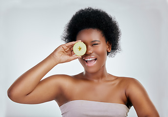 Image showing Happy black woman, portrait and apple for diet, natural nutrition or health against a white studio background. Face of African female person smile with organic fruit for fiber, vitamins or body care