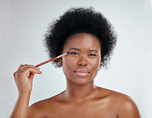 Image showing Black woman, portrait and makeup brush on eyes for skincare beauty against a white studio background. Face of African female person applying eye product, cosmetics or lashes for facial treatment