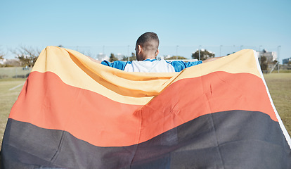 Image showing Germany, sports and man with a flag for soccer, motivation and training on a field. Back, fitness and professional athlete or person with representation of a country at a football game or competition